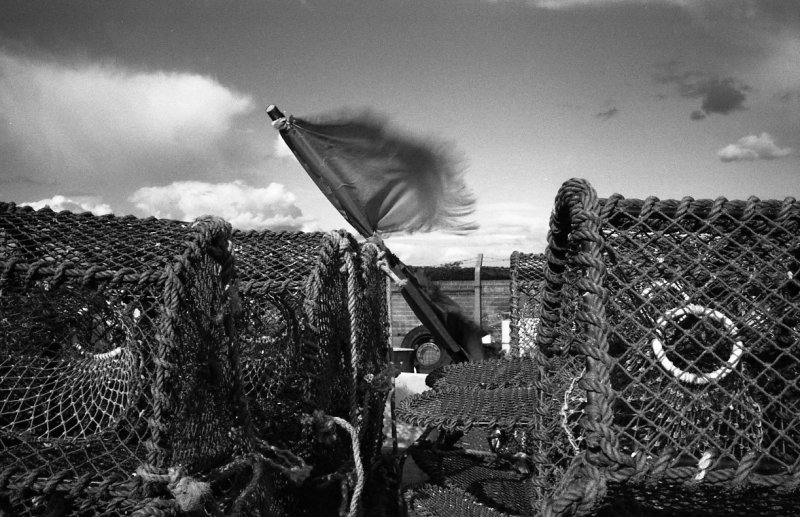 'Old Flag And Lobster Pots, Amble' by Richard Stent LRPS